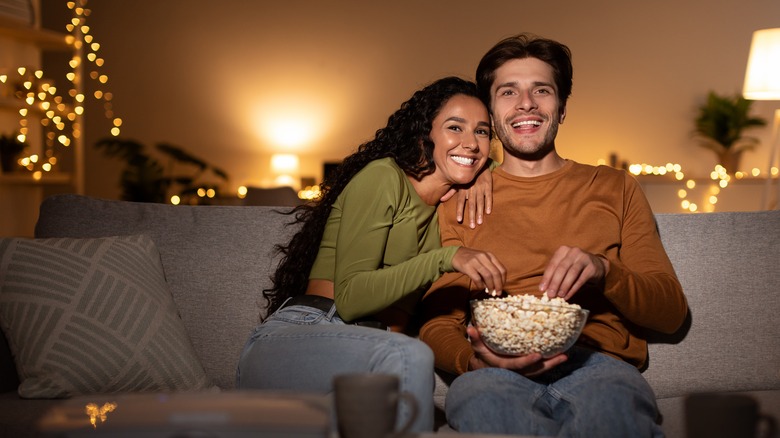 Couple sitting on the couch watching a movie