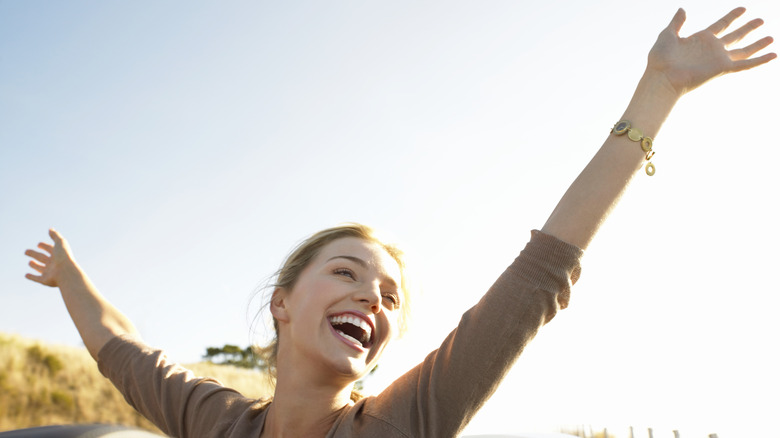 happy woman with arms up 