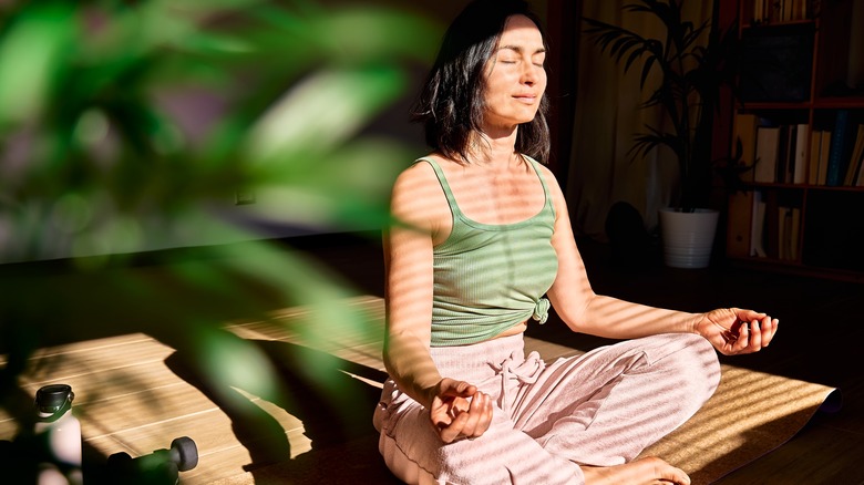 woman meditating in sunlight