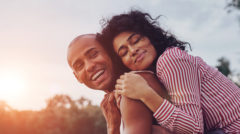 young black couple smiling and hugging