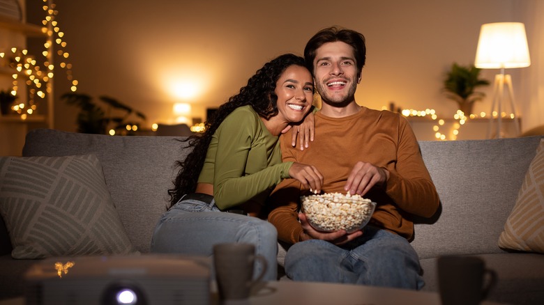 young couple snuggling on couch