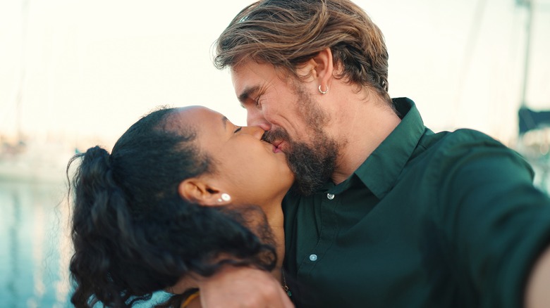 young couple kissing and laughing