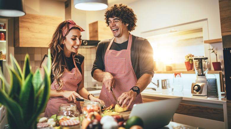 couple cooking and laughing