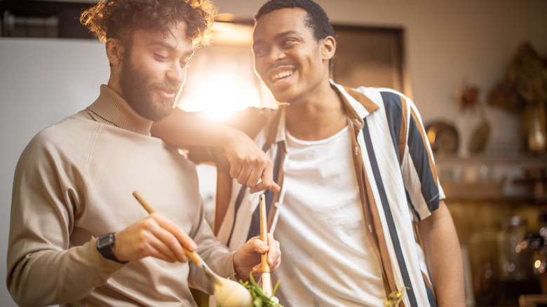 couple laughing and making dinner