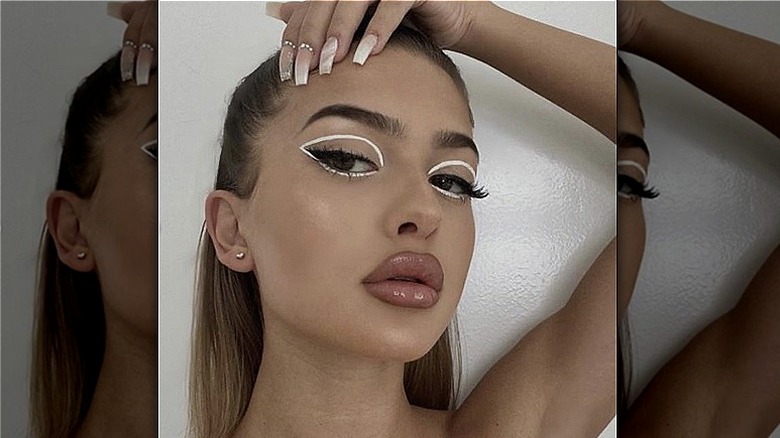 Woman models white graphic liner 