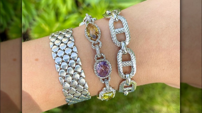 Three stacked white gold bracelets 