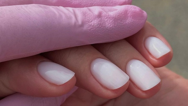 A woman with soft white nails