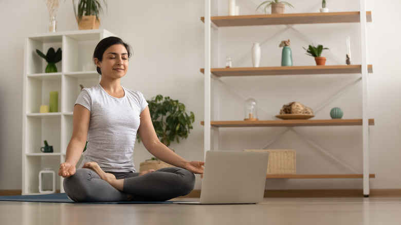 Woman meditating at home