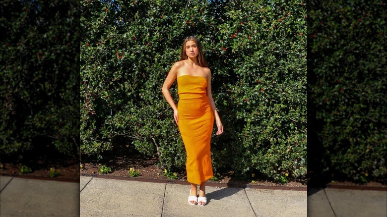 Woman wearing orange skirt set