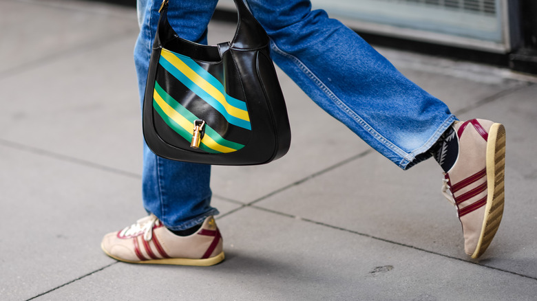 Colorful striped bag beige and red sneakers