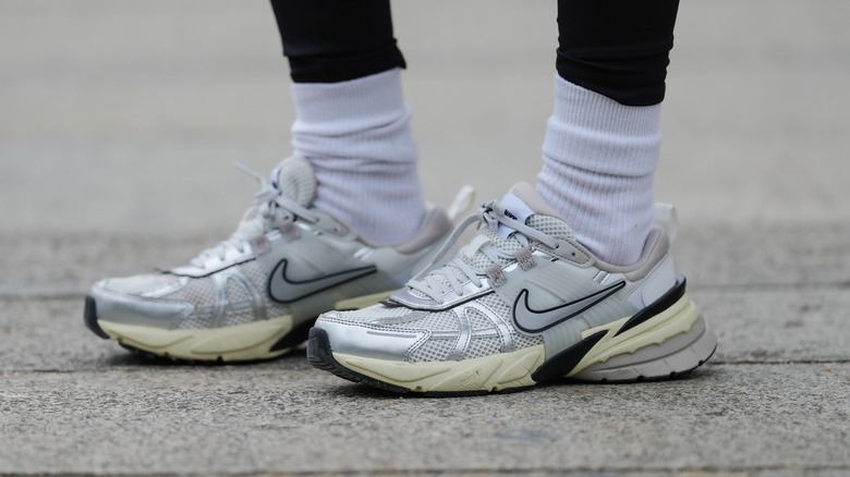 Woman wearing silver Nike sneakers