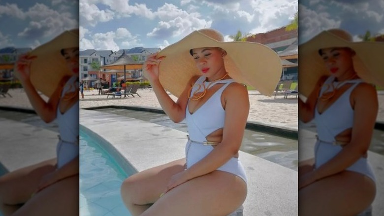 Woman in white swimsuit and hat