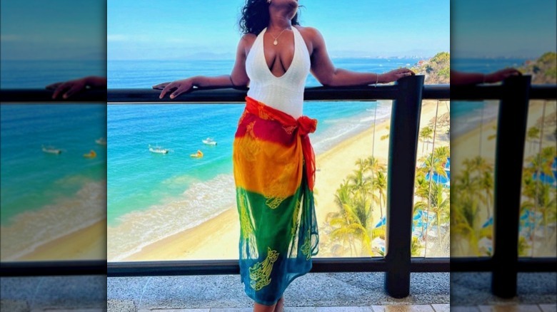 Woman in white swimsuit and sarong