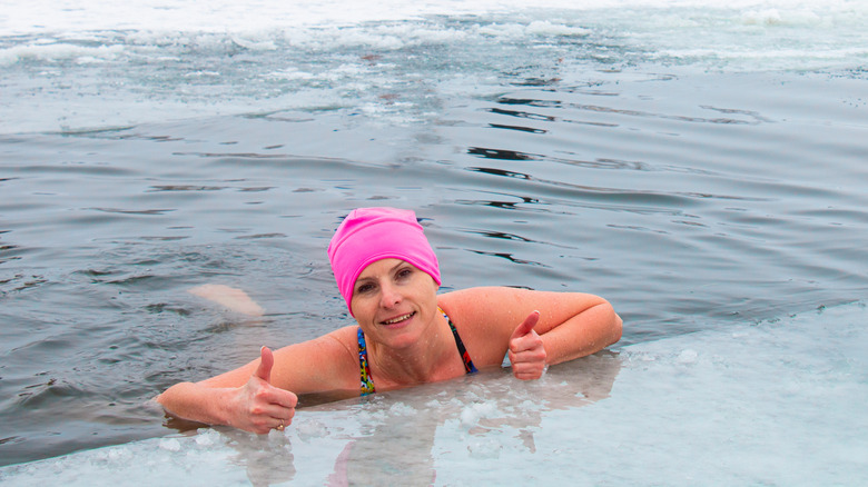 woman in an ice hole swimming