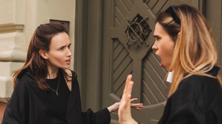 Two women arguing outside