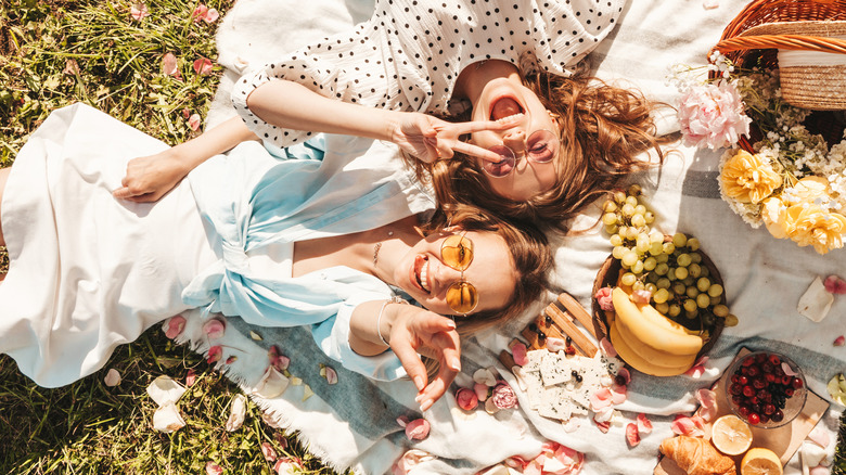 Two women laying picnic