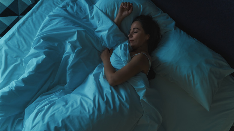 woman sleeping alone in bed