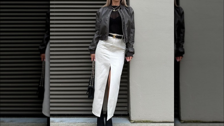 Woman in leather jacket and midi skirt