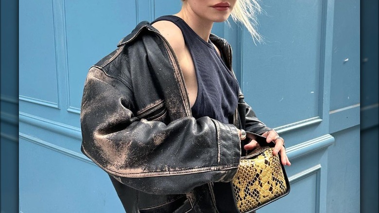 Woman in faded leather jacket