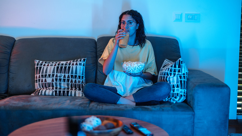 woman on sofa watching TV