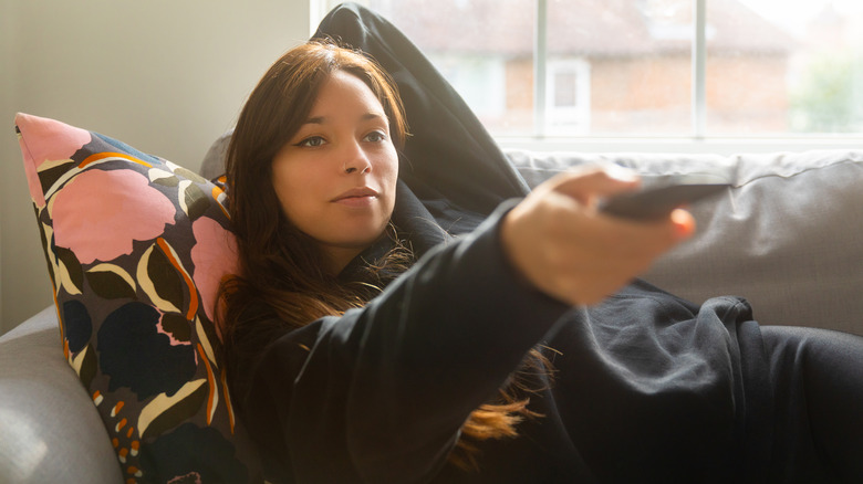 woman using TV remote