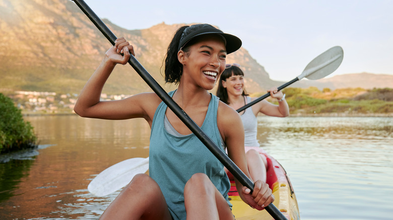 Smiling female couple kayaking