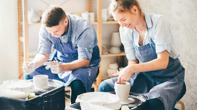 Happy couple making pottery