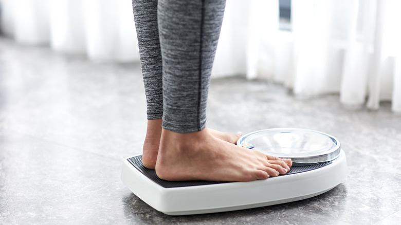 A woman weighing herself