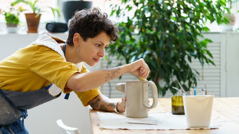 Woman focusing on pottery