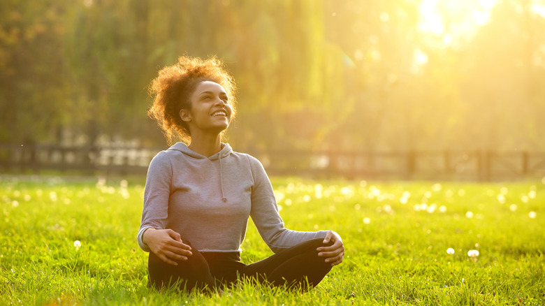 Happy woman in meditation outside