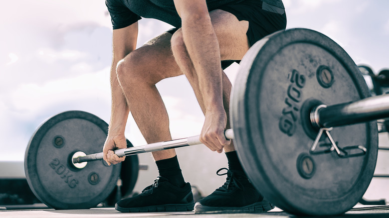 Person bending, lifting weights