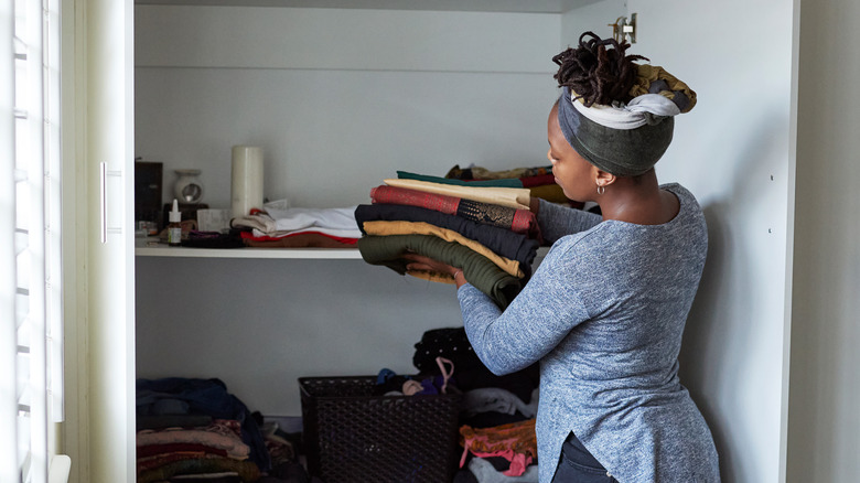 Woman cleaning out wardrobe