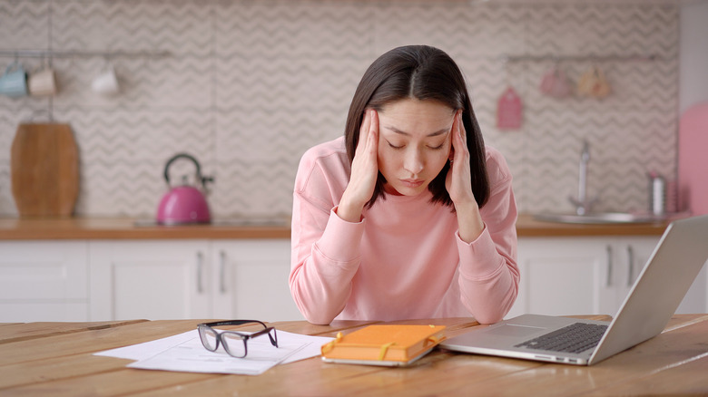 Asian woman looking stressed