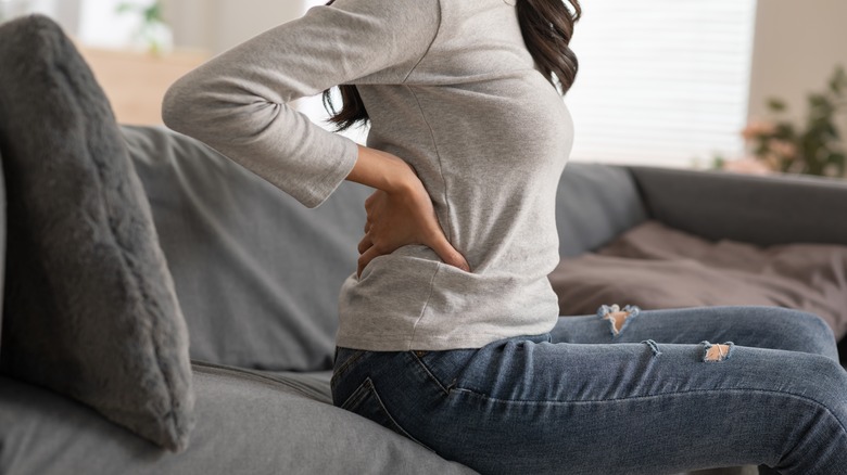 Woman holding back in pain