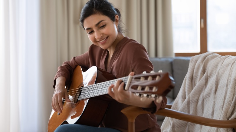 woman playing guitar