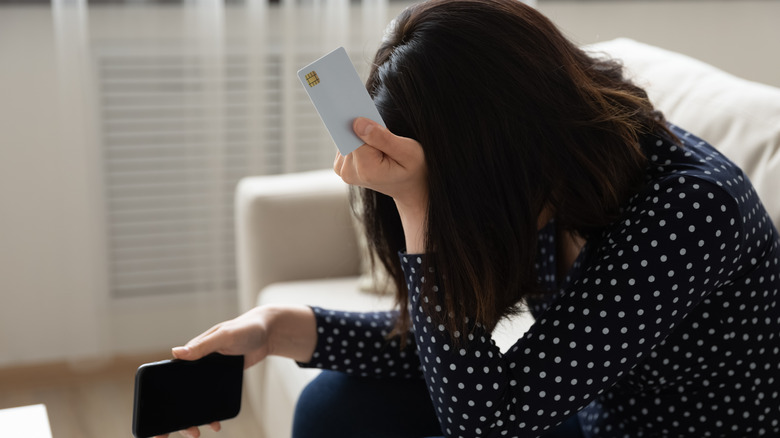 Distraught woman with credit card