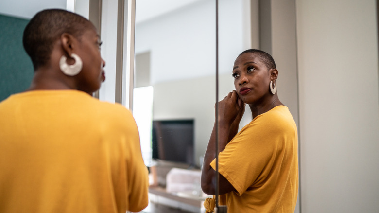 Woman looking in mirror