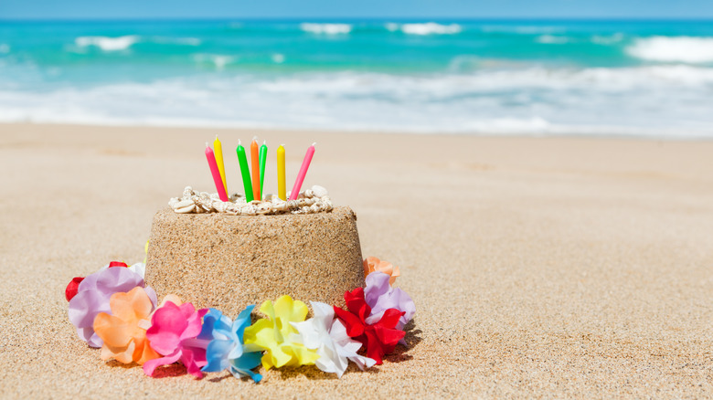 Sand birthday cake on beach