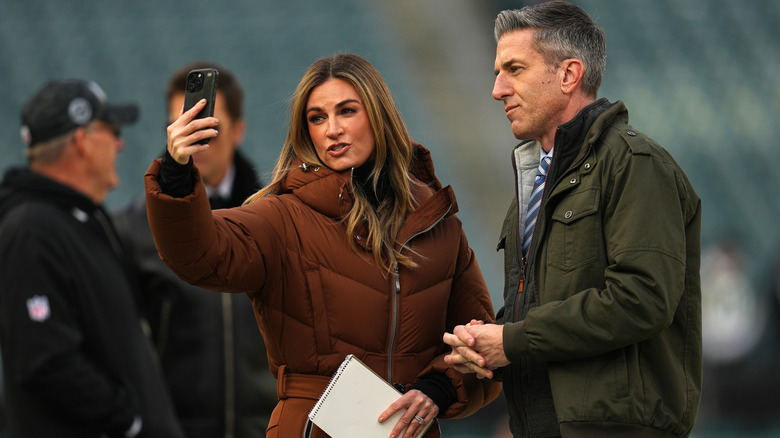 Erin Andrews wearing a brown ski suit while taking a selfie