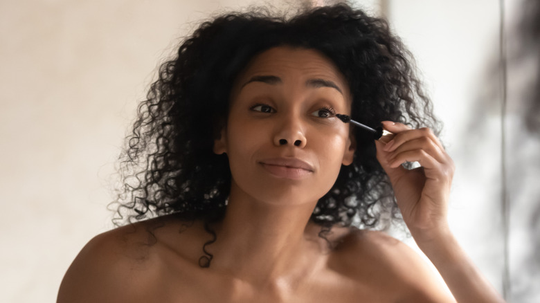 woman applying mascara