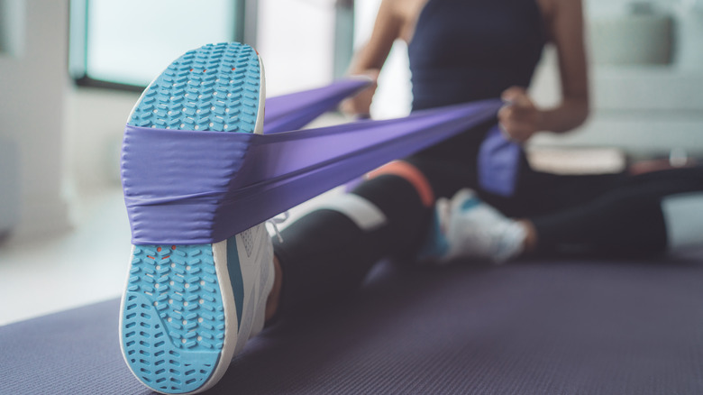 Woman stretching with resistance band