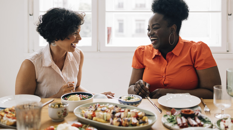 Women laughing at dinner party