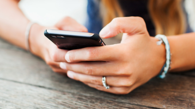 woman holding phone