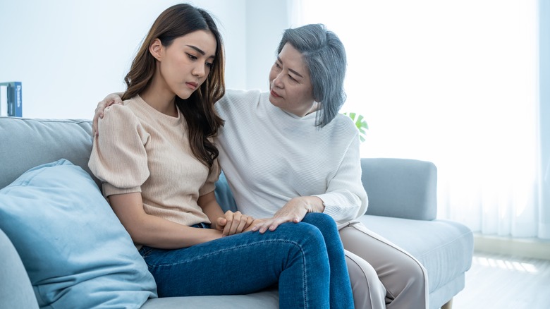 mother comforts daughter