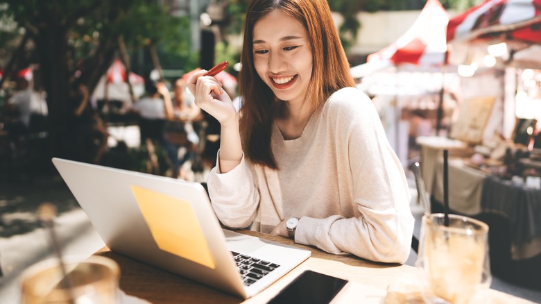 Woman on computer in public