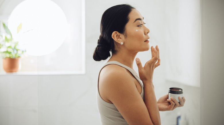 Woman applying skincare