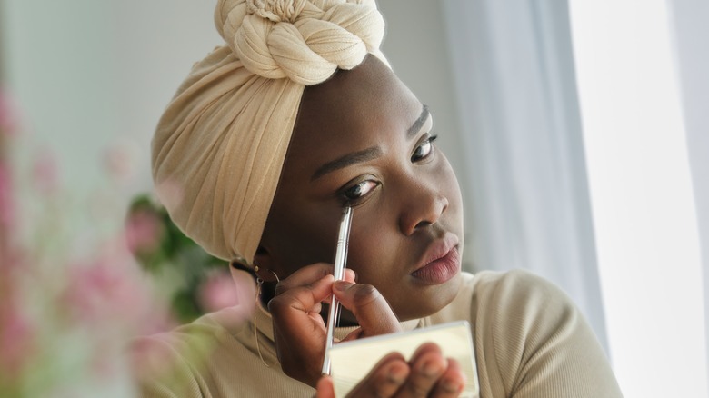 Woman applying eye makeup