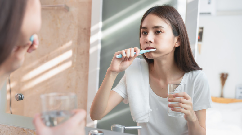 woman brushing teeth