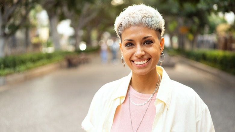 Woman wearing earrings, smiling