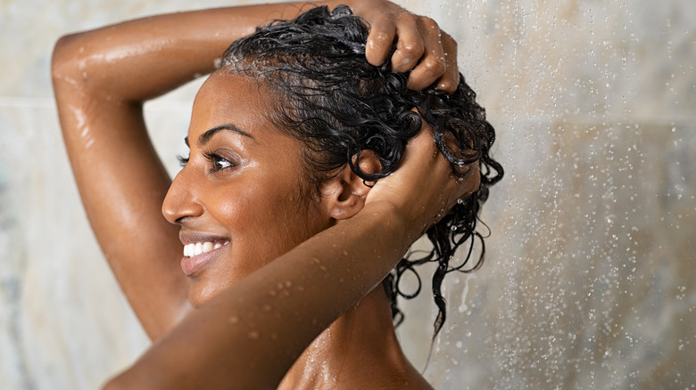 Woman showering in lukewarm water